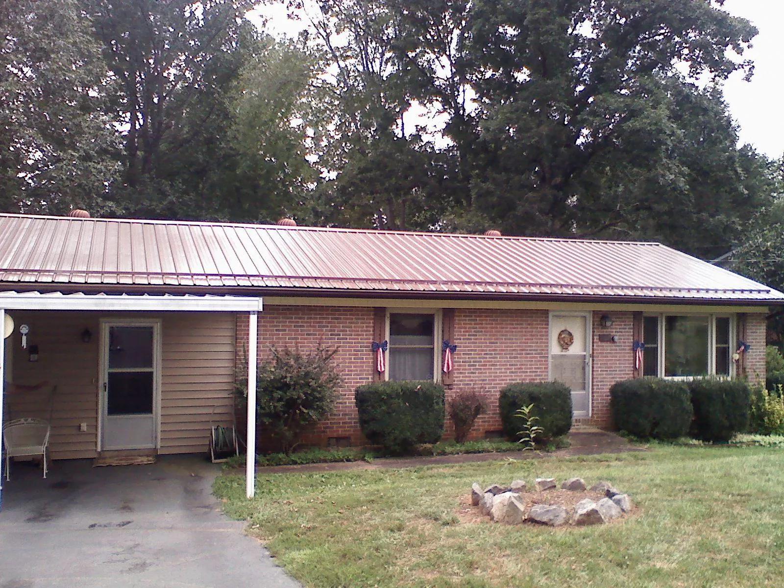 Bronze metal roof and carport on a brick ranch home — Roof Repair work by our crew in Ridgewood